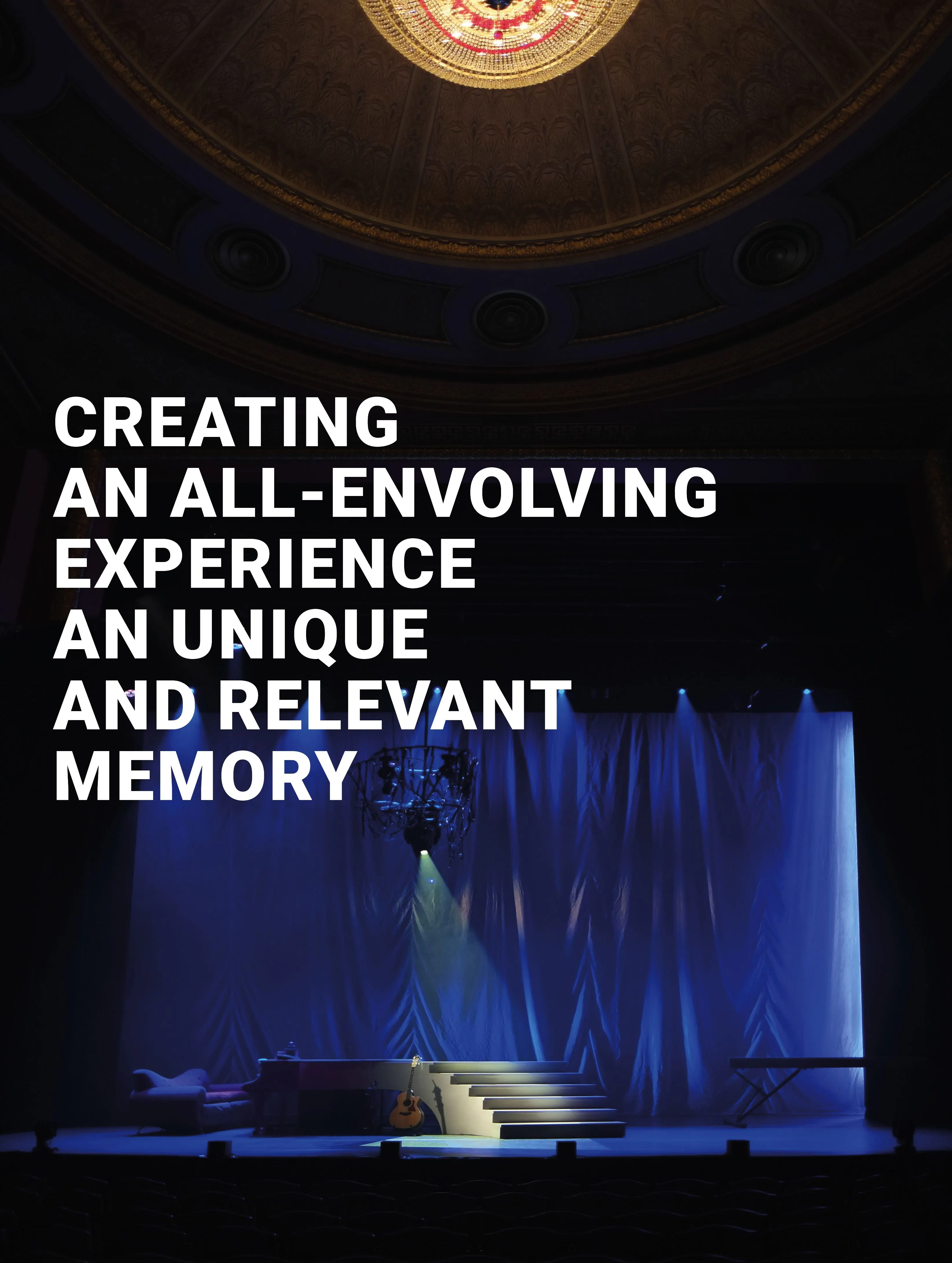 Dark theatre stage with blue curtains and an ornate ceiling, with the text 'Creating an all-envolving experience'