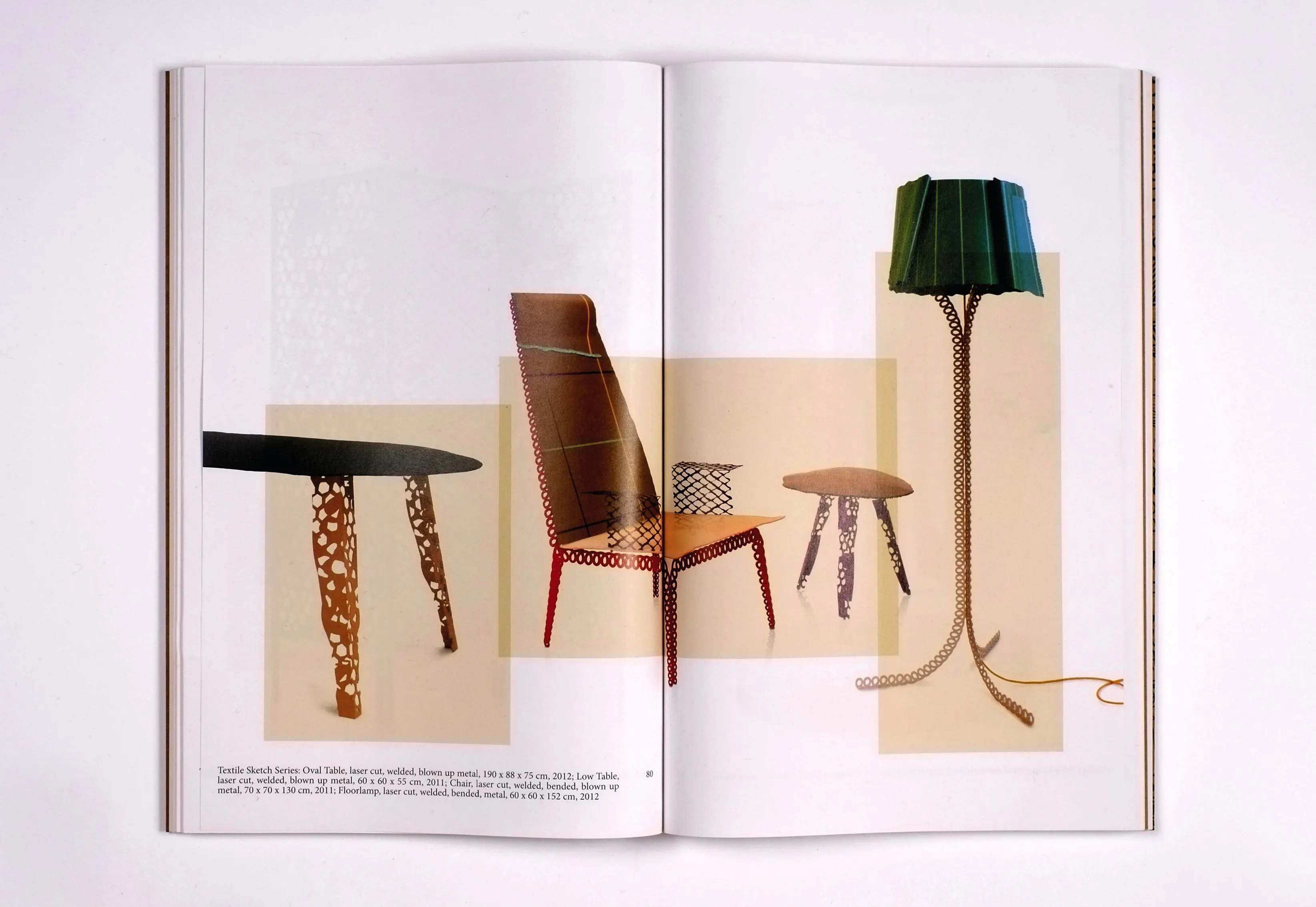 Book spread with photos of furniture: a table, a chair with a tall back and a floor lamp with a green shade