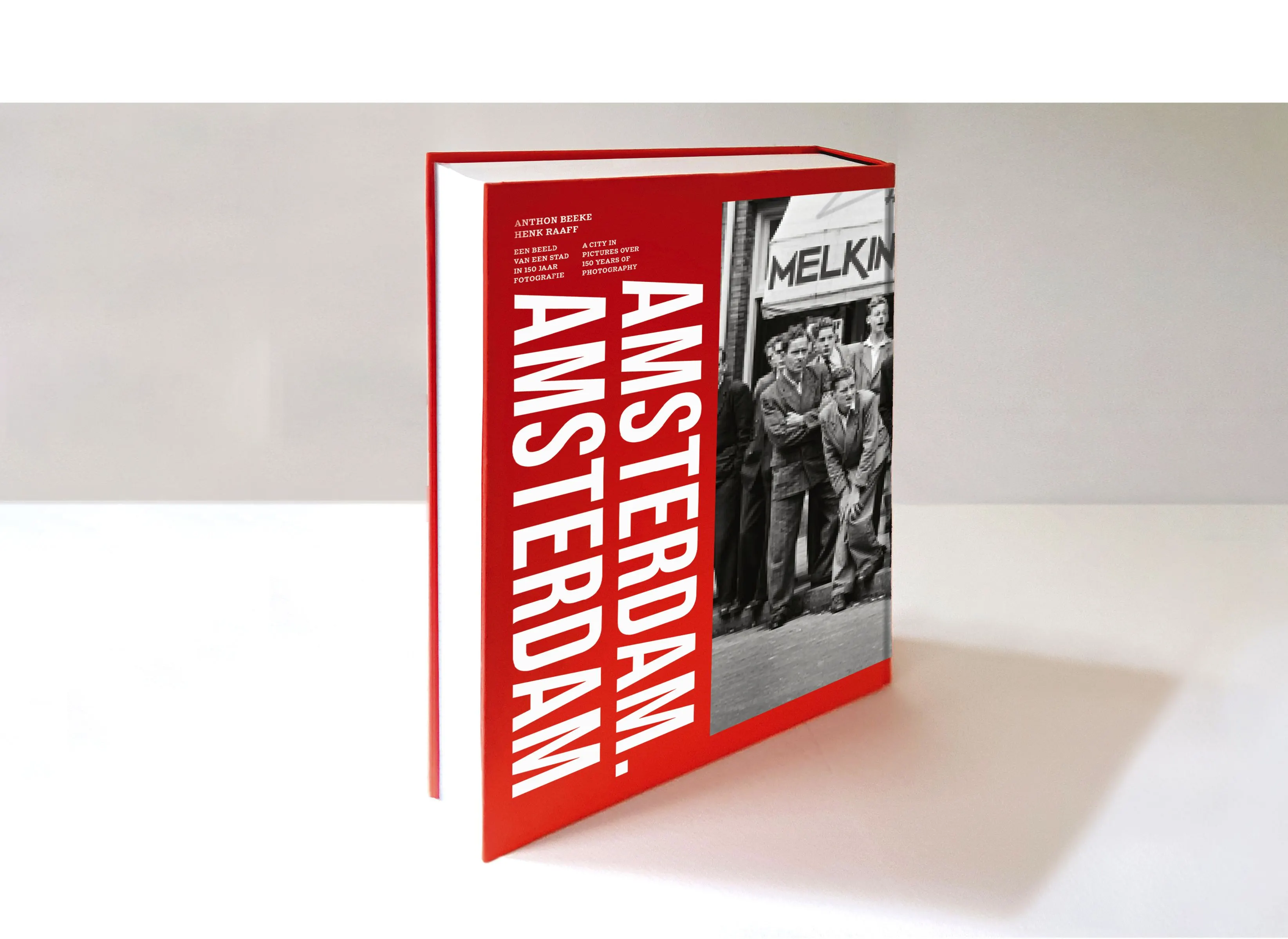 Book ‘Amsterdam. Amsterdam’ standing upright, red cover with vertical white title and a cropped black-and-white photo
