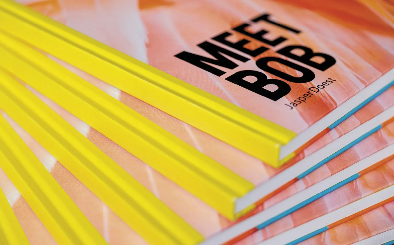 Stack of 'Meet Bob' books with bright yellow spines and a pink-orange flamingo cover, title and author Jasper Doest