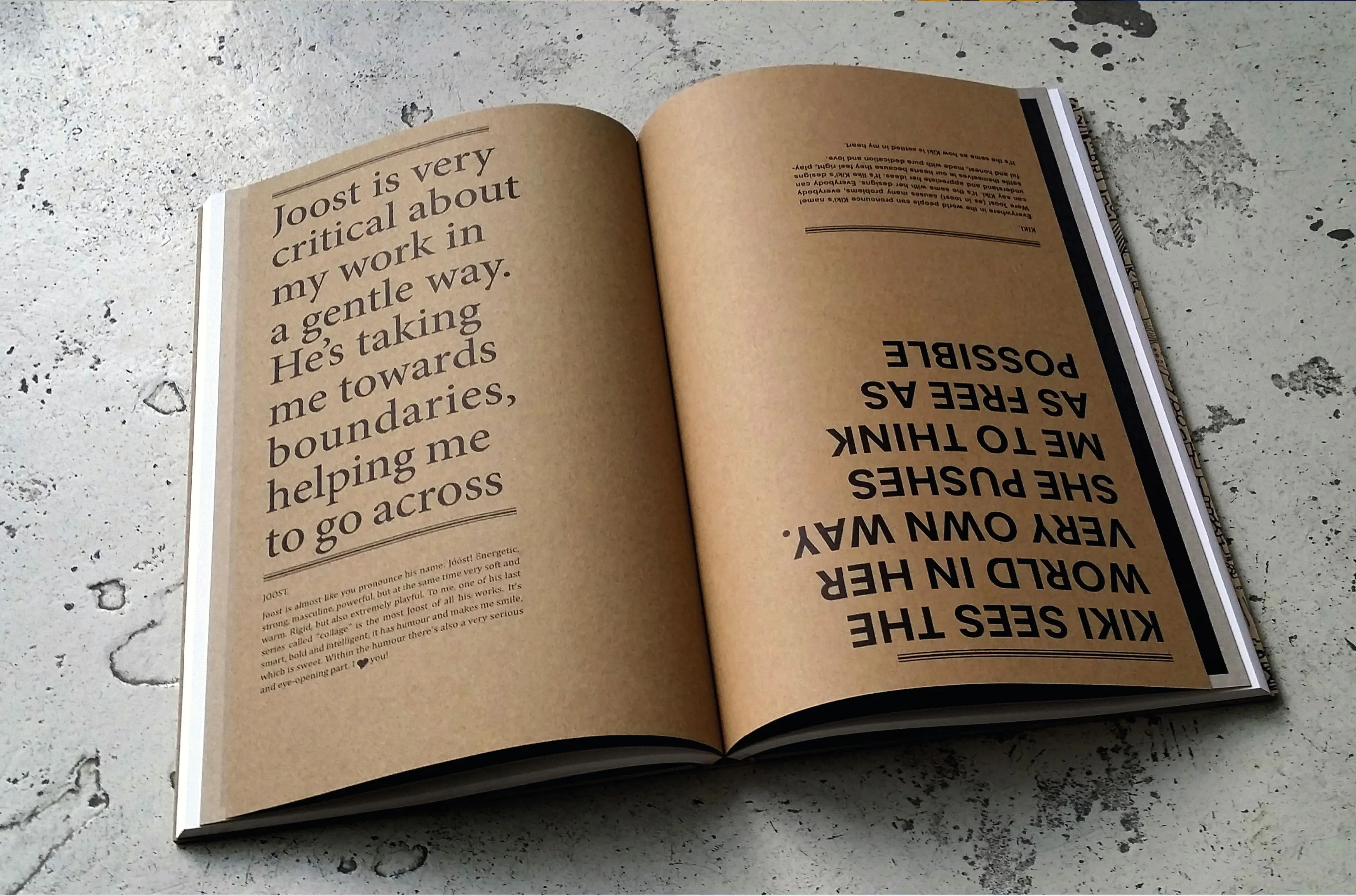 Open book on kraft paper with quotes about Joost and Kiki, one upside down, printed in serif type