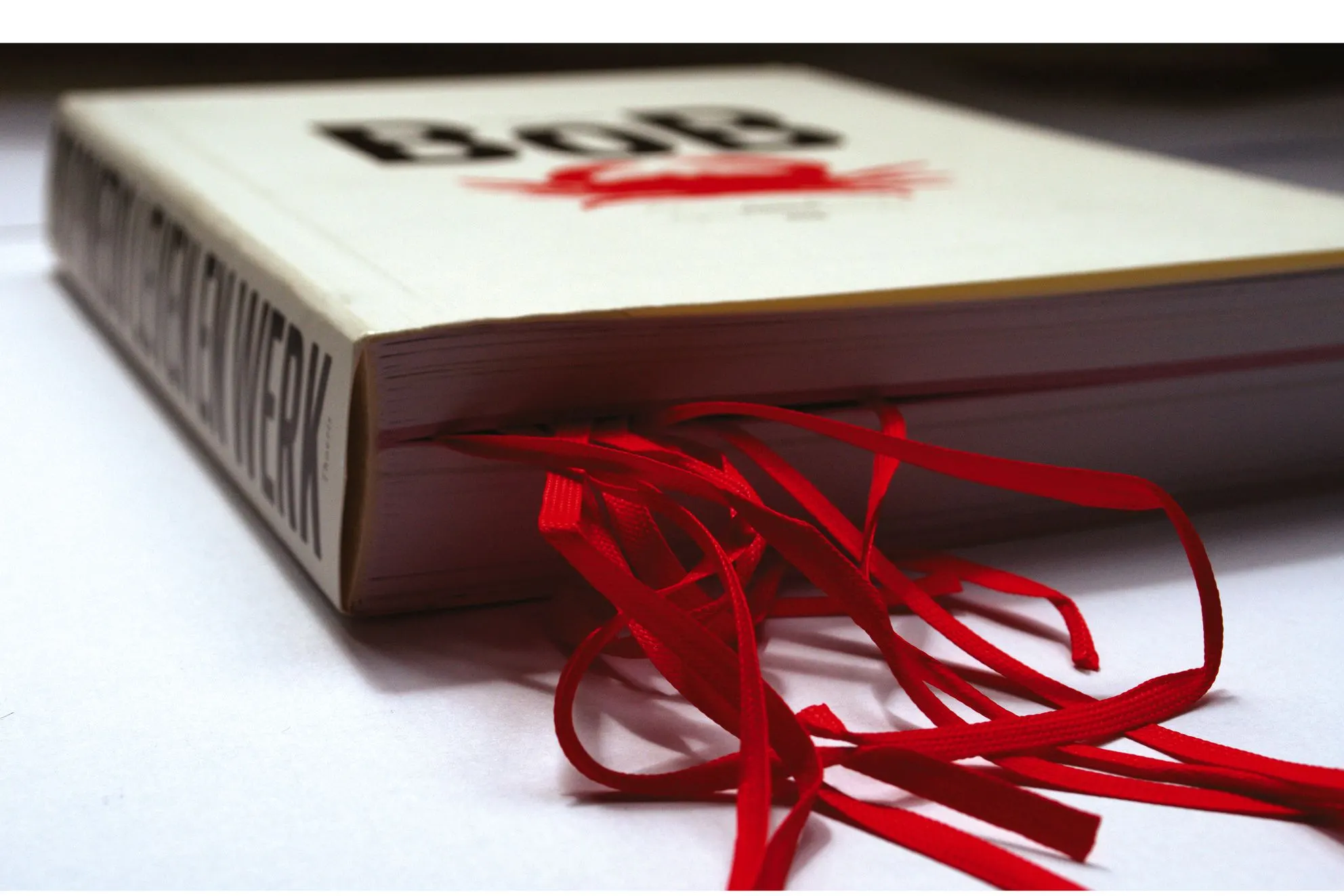 Close-up of the closed BoB book showing the red crab on the cover and red ribbons spilling from the pages