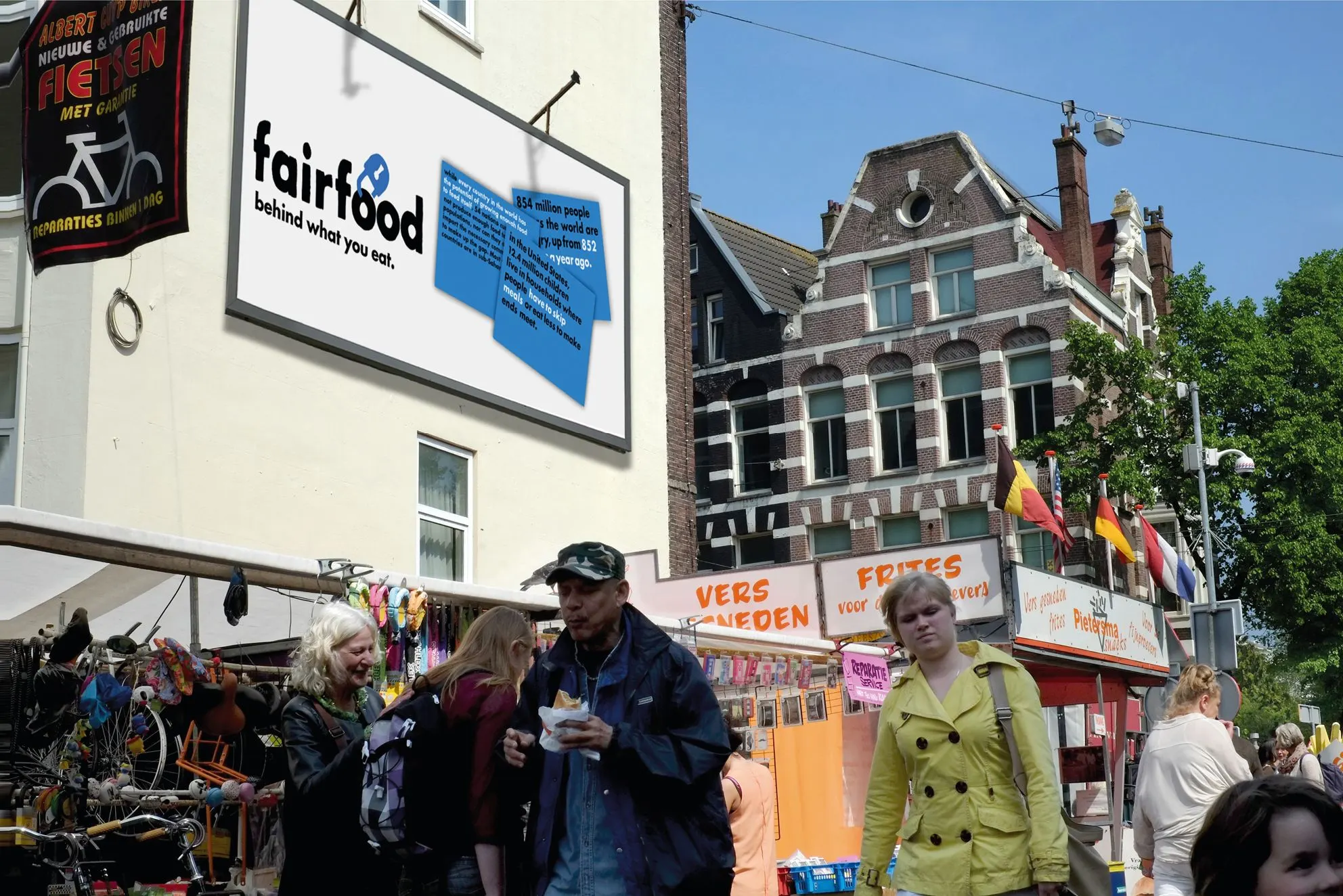 Fairfood billboard on a building facade above a busy street market in Amsterdam, tagline ‘behind what you eat.’