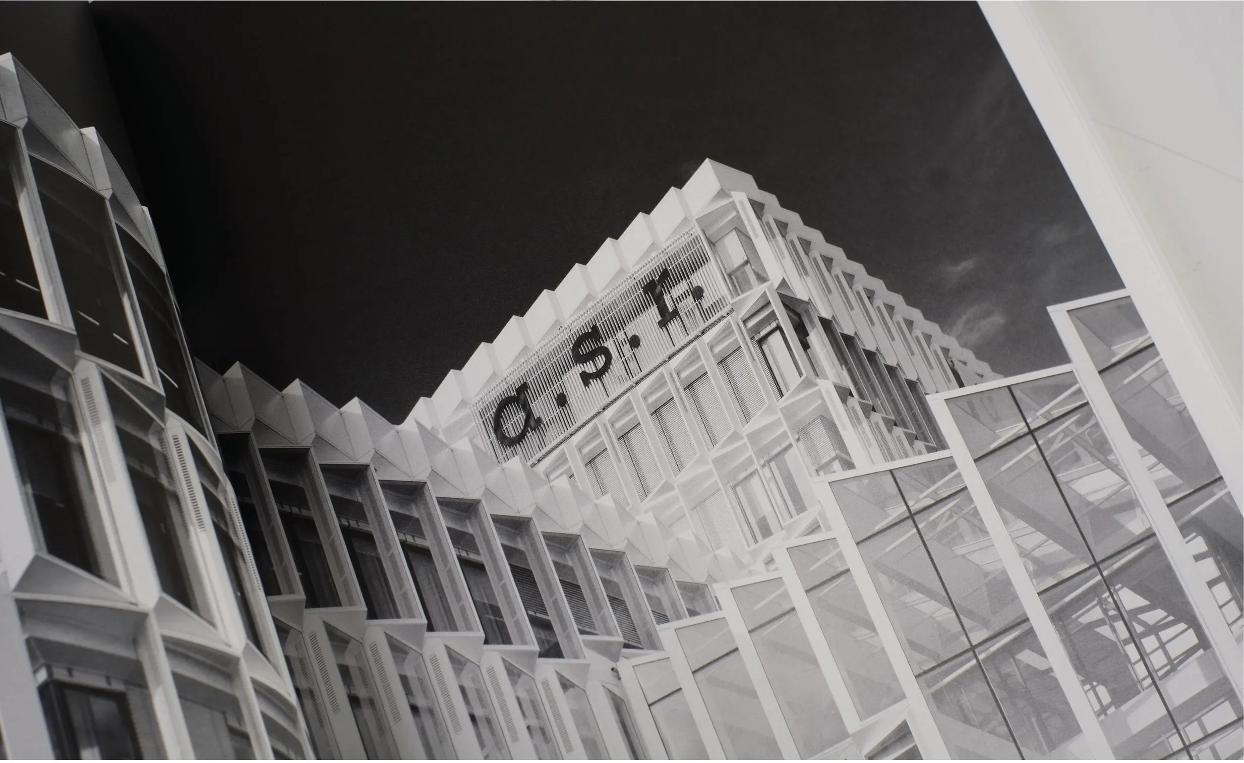 Black and white photo looking up at the angular facade of the a.s.r. building with its logo