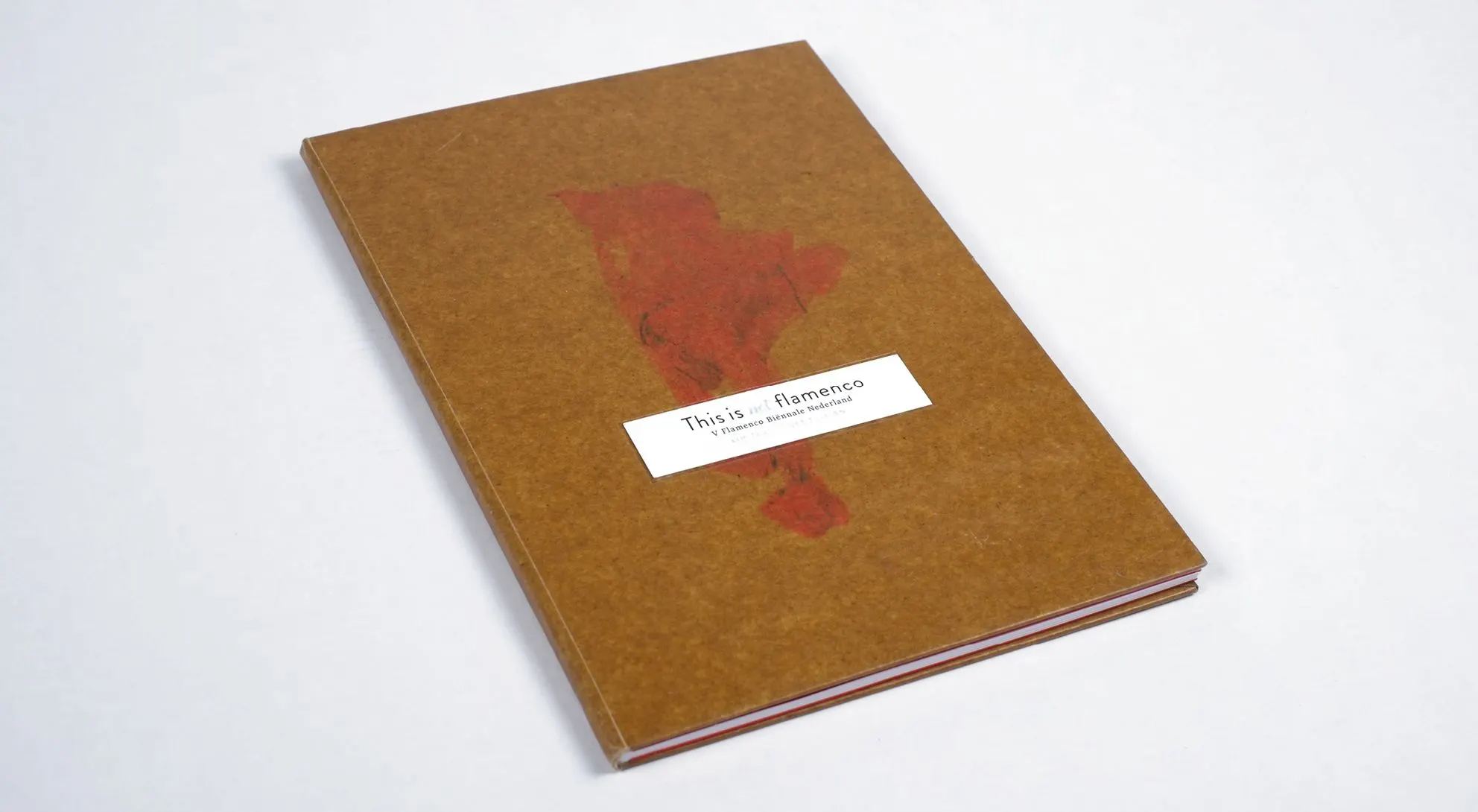 Hardcover jubilee book This is not flamenco with brown cardboard cover, red fabric motif and white label