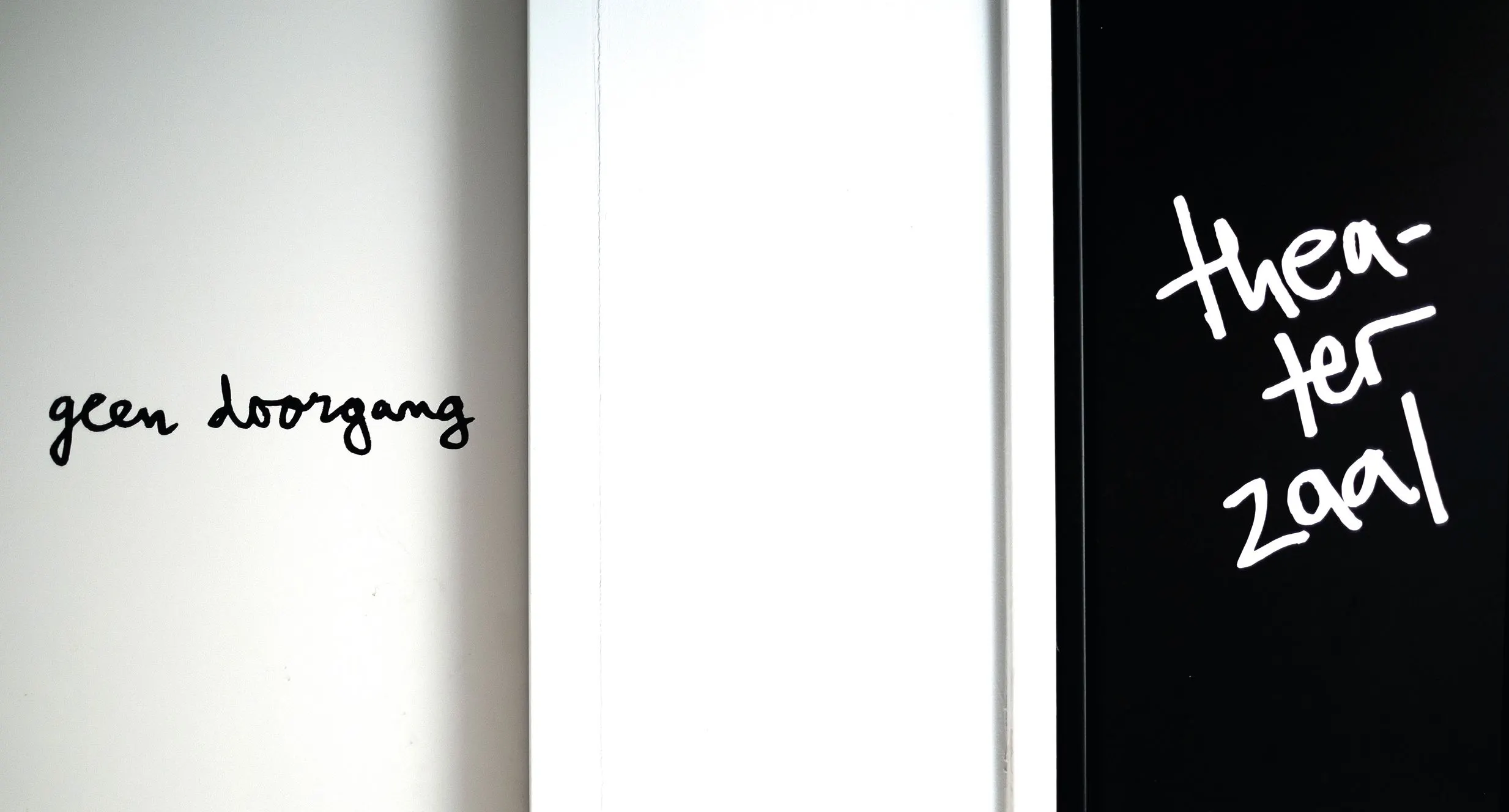 Door signage with handwritten ‘geen doorgang’ on white and ‘theaterzaal’ in white on a black door